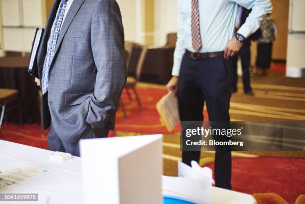 Job seekers stand in line to speak with a representative during a National Career Fair event in Edison, New Jersey, U.S., on Thursday, Sept. 20,...