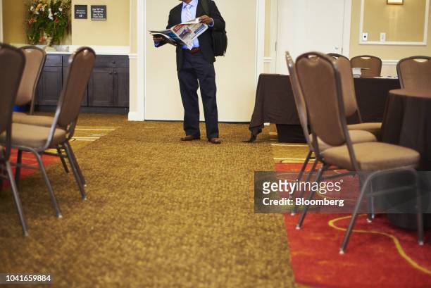 Job seeker reads an employment newsletter during a National Career Fair event in Edison, New Jersey, U.S., on Thursday, Sept. 20, 2018. Filings for...
