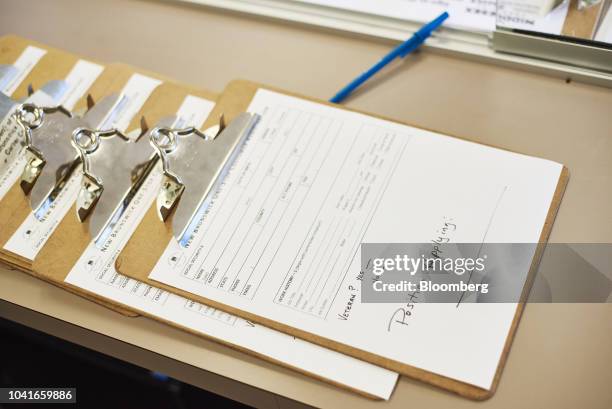 Applications sit on a counter during a job recruitment event for Banker Steel Co. In New Brunswick, New Jersey, U.S., on Wednesday Sept. 19, 2018....