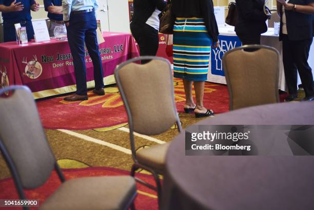 Job seekers speak with representatives during a National Career Fair event in Edison, New Jersey, U.S., on Thursday, Sept. 20, 2018. Filings for U.S....