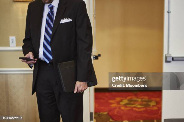 Job seeker views a mobile device during a National Career Fair event in Edison, New Jersey, U.S., on Thursday, Sept. 20, 2018. Filings for U.S....