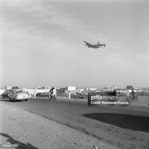 Un avion militaire dans le ciel prêt à atterrir après le tremblement de terre à Agadir, Maroc, en 1960.