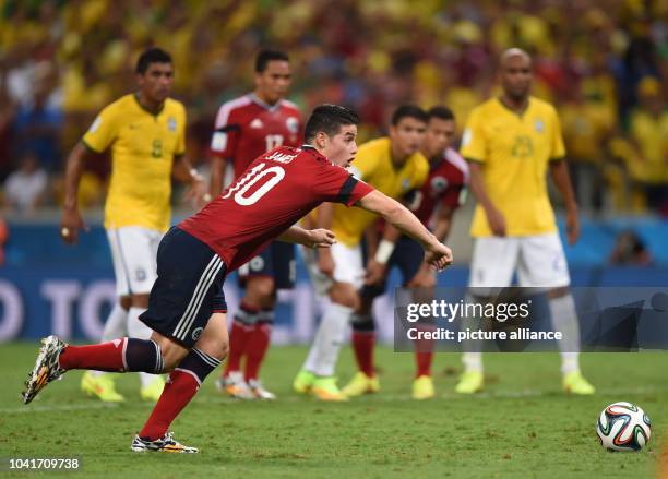 James Rodriguez of Colombia scores the 2-1 goal from the penalty spot during the FIFA World Cup 2014 quarter final match soccer between Brazil and...
