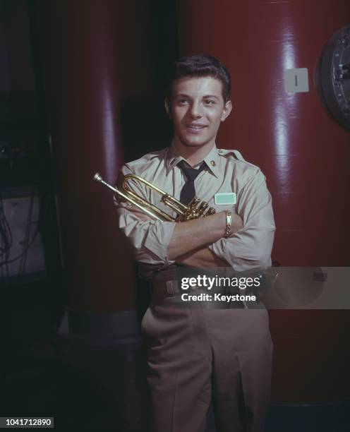 Italian-American actor, singer and musician Frankie Avalon holding his trumpet on the set of the 20th Century Fox science fiction film 'Voyage to the...