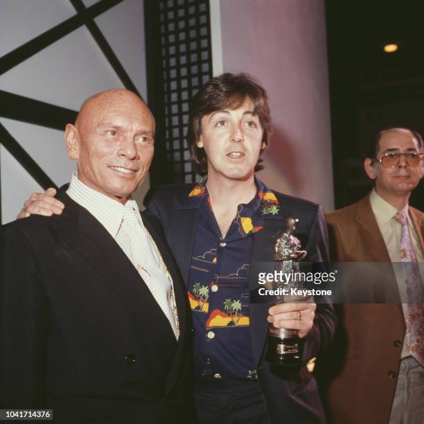Russian-born actor Yul Brynner with former Beatle Paul McCartney after presenting the singer with an Ivor Novello award at Grosvenor House in London,...