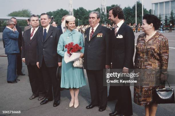 King Carl XVI Gustaf and Queen Silvia of Sweden are accompanied by Russian leader Leonid Brezhnev and Andrei Gromyko upon their departure from...