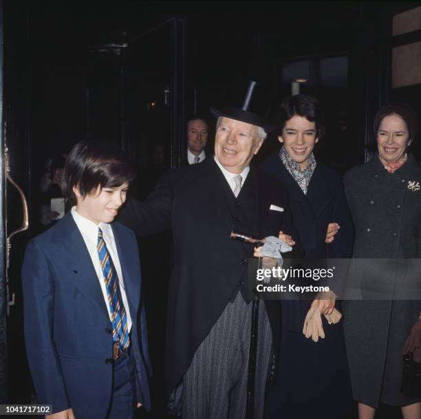 Actor and director Sir Charlie Chaplin with his family in London, where he is receiving a KBE, 4th March 1975. From left to right, his son...