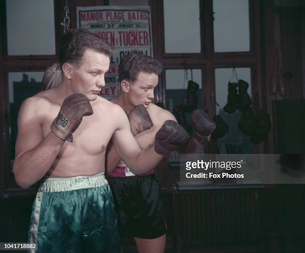 English boxers Henry Cooper and his identical twin brother George Cooper , circa 1966.