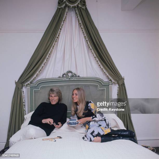 English pop singer Adam Faith at home with his wife Jackie Irving, UK, circa 1970.