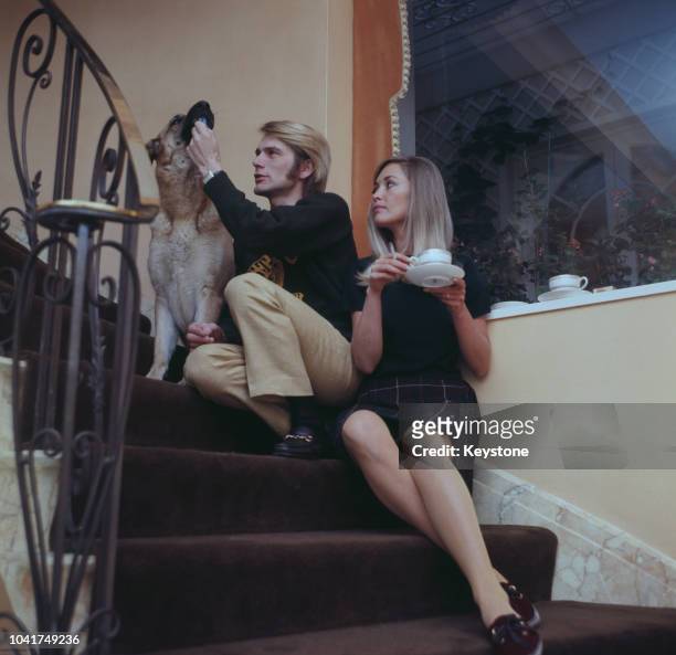 English pop singer Adam Faith at home with his wife Jackie Irving, UK, circa 1970.