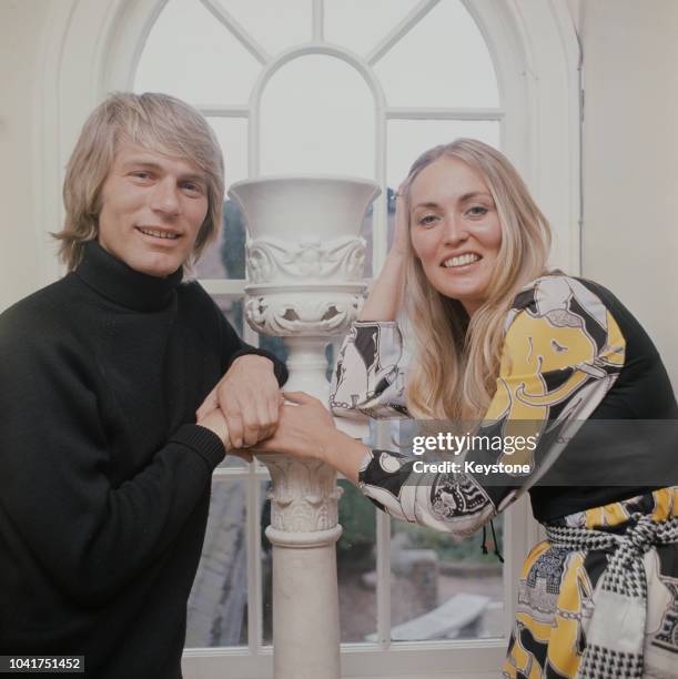 English pop singer Adam Faith at home with his wife Jackie, circa 1970.