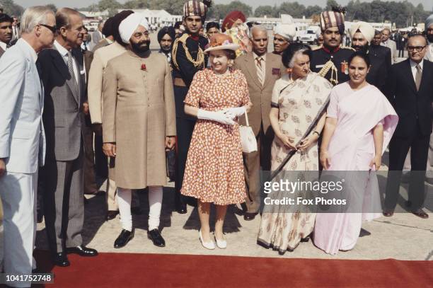 Queen Elizabeth II and Prince Philip are met by Indian Prime Minister Indira Gandhi and President Zail Singh at Palam Airport, New Delhi, during a...