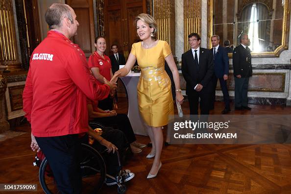 Queen Mathilde of Belgium shakes hands during a reception for medal ...