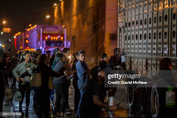 Animal rights activists give water to pigs arriving by truck to the Farmer John slaughterhouse in the early morning hours on September 27, 2018 in...