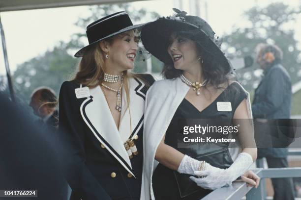 Models Jerry Hall and Marie Helvin at Royal Ascot in Berkshire, UK, 1982.