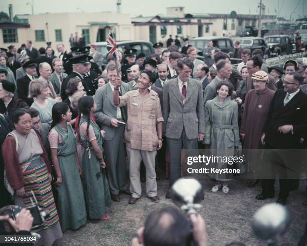 Sherpa Tenzing Norgay and Edmund Hillary arrive at London Airport with expedition leader John Hunt, after their successful ascent to the summit of...