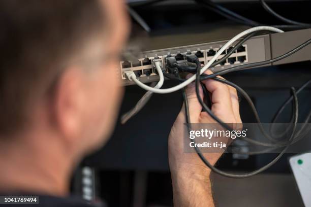 it consultant working with network switches - internet router stock pictures, royalty-free photos & images