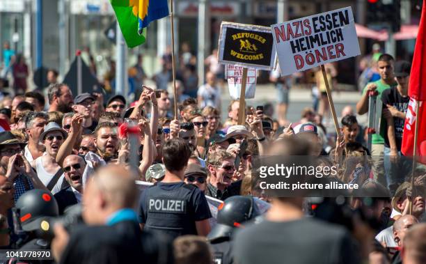 Left-wing demonstrants of the 'Initiative nazi-free Rosenheim' hold a banner that reads "Nazis essen heimlich Döner" at the train station Rosenheim,...