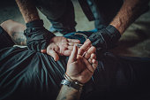 Police putting handcuffs on a man
