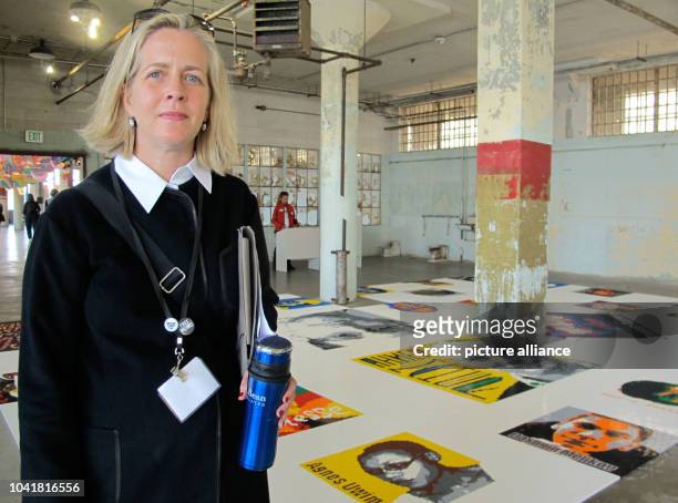 Marnie Burke de Guzman, organizer of the Ai Weiwei exhibit on Alcatraz island, stands in September with the "Trace" exhibit in a dilapidated work...