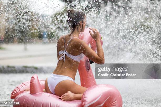 end of summer in germany - woman under a fountain - göttingen stock-fotos und bilder