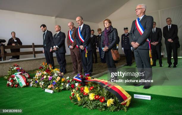 Members of public life in the region place wreaths at the collective grave in the cemetery following the memorial service for the victims of the...