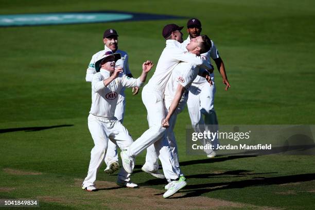 Morne Morkel of Surrey celebrates dismissing Simon Harmer of Essex during day three of the Specsavers County Championship Division One match between...