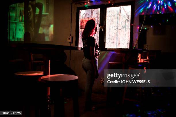 Young girl, who is now afraid to go out at night, is seen at a bar on September 26, 2018 in Kinshasa, in the Democratic Republic of the Congo. -...