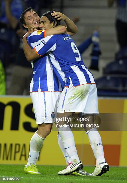 Porto's forward Radamel Falcao from Colombia celebrates with teammate midfielder Joao Moutinho after scoring against Rapid Vienna during their UEFA...