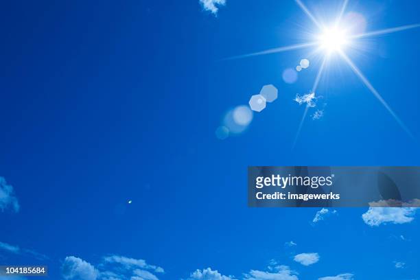 low angle view of blue sky - sun flare clouds sky stock pictures, royalty-free photos & images