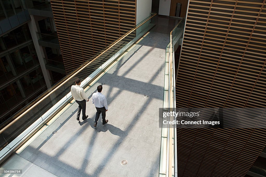 Businessmen on office walkway