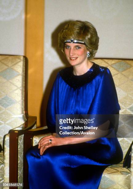Diana, Princess Of Wales, at a dinner hosted By Emperor Hirohito in Japan, She is wearing a pleated royal blue evening dress designed by fashion...