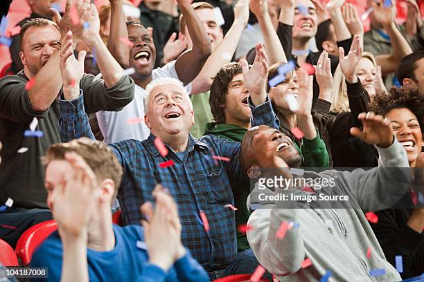 ticker tape falling on crowd - crowd cheering stock pictures, royalty-free photos & images