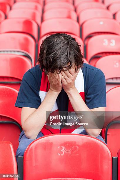 disappointed football fan in empty stadium - man cry touching stock pictures, royalty-free photos & images