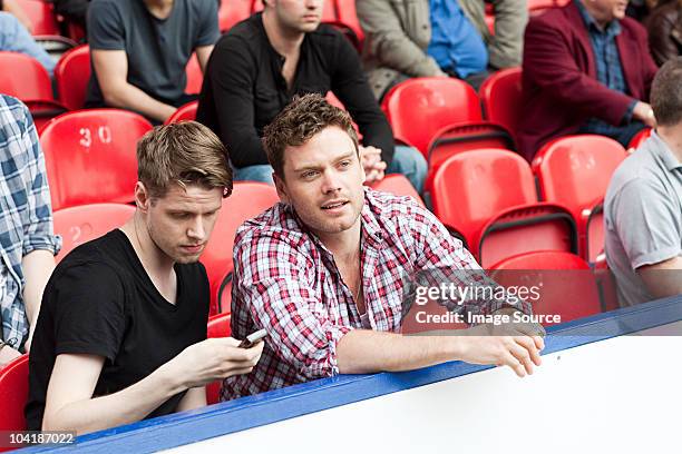 young men at football match - football phone stock pictures, royalty-free photos & images