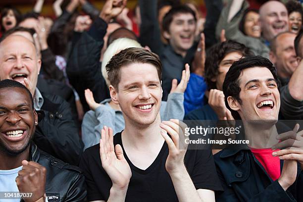 fans clapping at football match - happy fans stock pictures, royalty-free photos & images