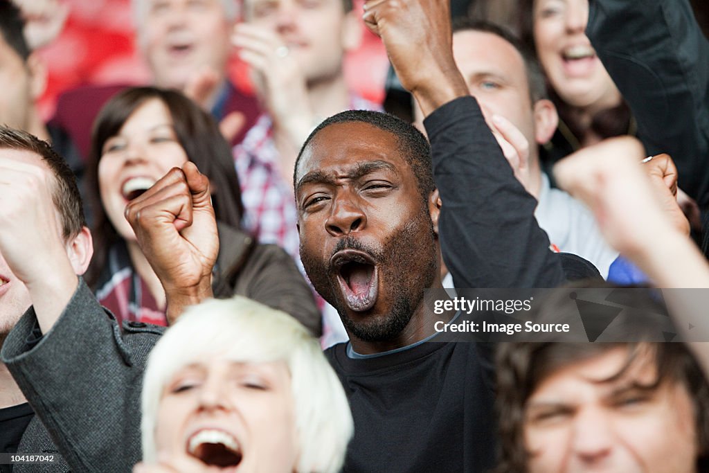 Cheering man at football match