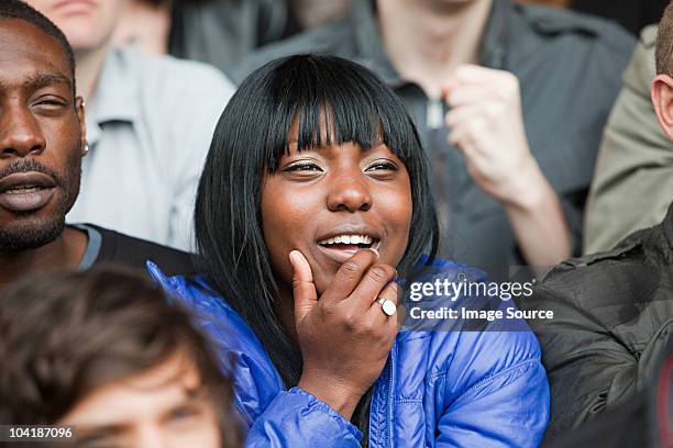 woman watching football match - crowd anticipation stock pictures, royalty-free photos & images
