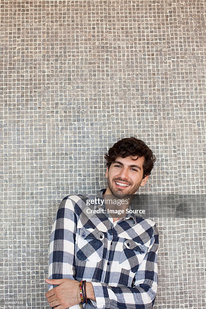 Portrait of young man in front of wall