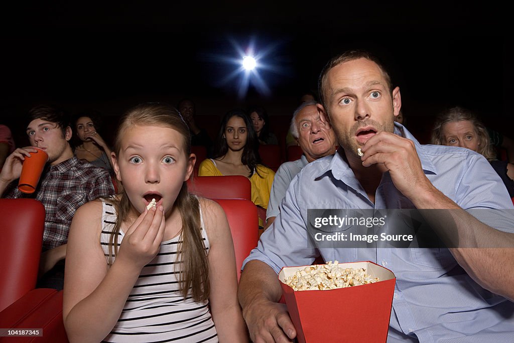 Shocked father and daughter in movie theater