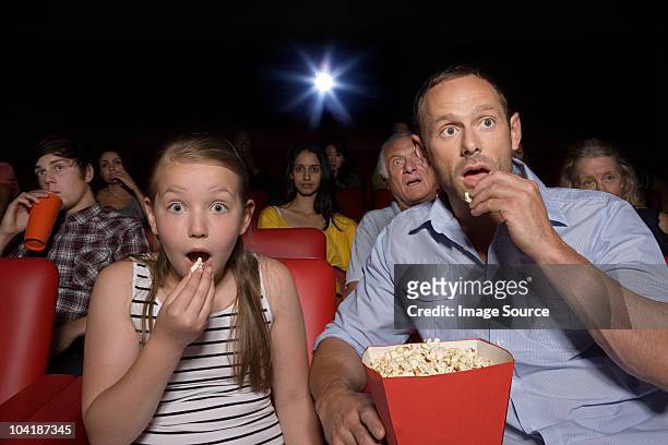 shocked father and daughter in movie theater - outrage 2010 film stock pictures, royalty-free photos & images