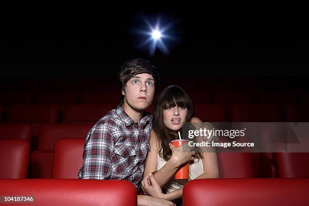 shocked young couple in the movie theater - outrage 2010 film stock pictures, royalty-free photos & images