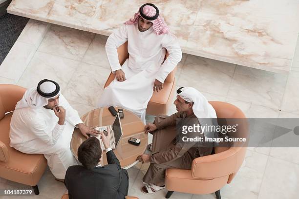 high angle view of businessmen having a meeting - ethnies du moyen orient photos et images de collection
