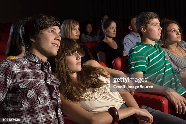 young couples watching a movie - teen dating stock pictures, royalty-free photos & images