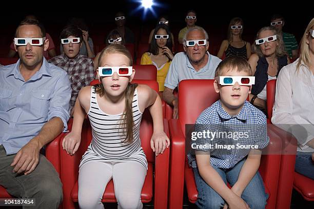 family watching 3d movie at the movie theater - 3 d glasses stock pictures, royalty-free photos & images