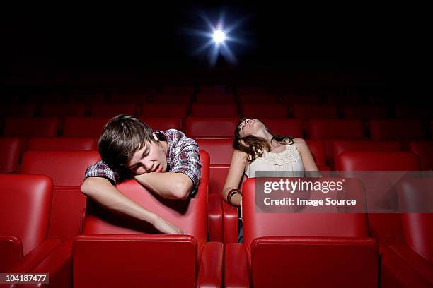 young couple asleep in the movie theater - bored audience stock pictures, royalty-free photos & images