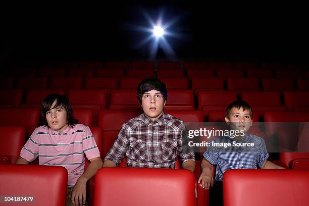 three boys in the movie theater - outrage 2010 film stock pictures, royalty-free photos & images