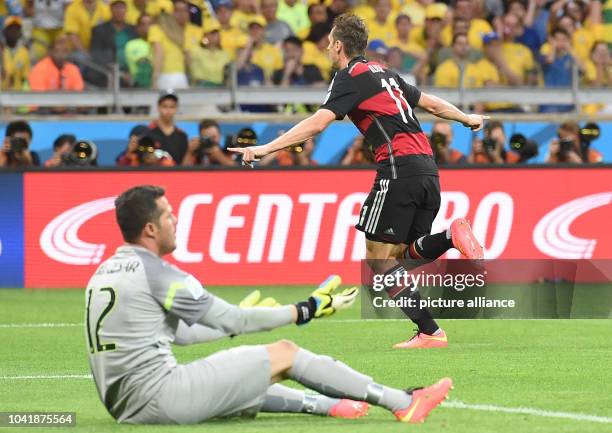 Miroslav Klose of Germany celebrates after scoring the 0-2 goal against goalkeeper Julio Cesar of Brazil during the FIFA World Cup 2014 semi-final...