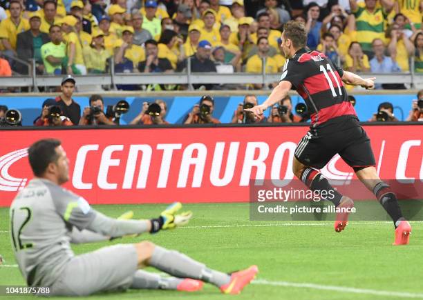 Miroslav Klose of Germany celebrates after scoring the 0-2 goal against goalkeeper Julio Cesar of Brazil during the FIFA World Cup 2014 semi-final...