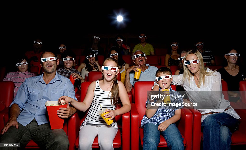 Family watching 3d movie at the movie theater